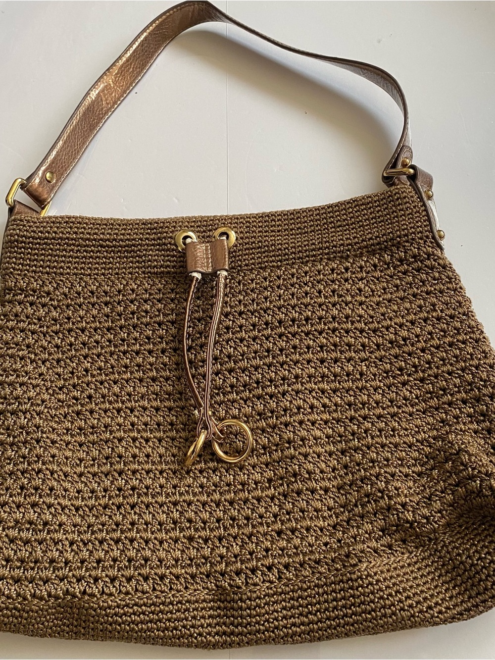 The Sak Beige Shoulder Bag with Gold Hardware and Blue Logo Tag